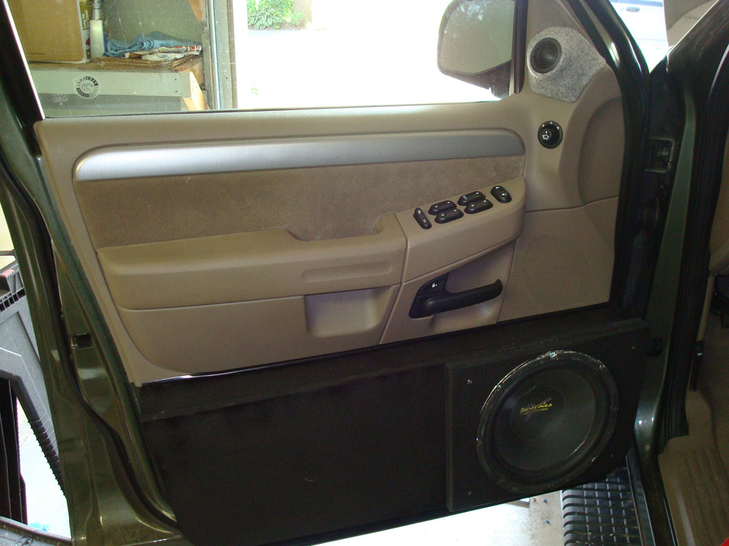 Here it is finished. I used automotive trim to cover the cut on the bottom of the door panel. Not chrome though like I see some people use to accent their door lines... The XS woofers look rough, but I didn't want to spend any more money on this install, 