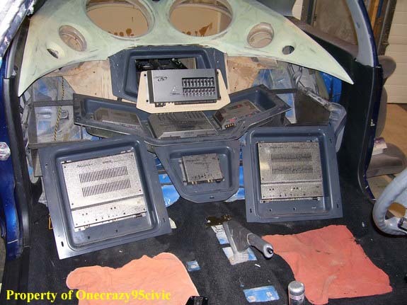Inside of the car, where the back seat used to be w/the motorized TiDD10 in the extend position, which expose a PG Ti400.2 amplifier.