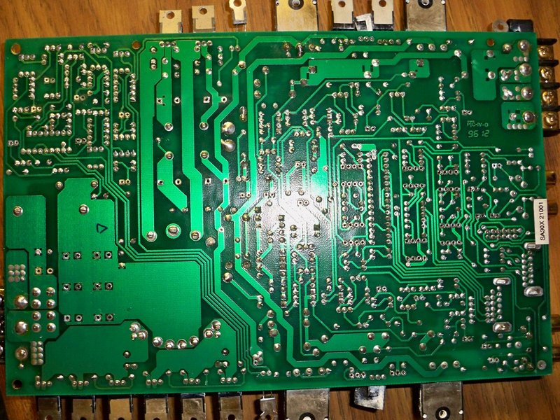 Bottom of pcb with all parts removed. Before I do any soldering I like to give the via pads a good brushing with my fiberglass pen, then add a tiny bit of flux and boom goes the dynamite.