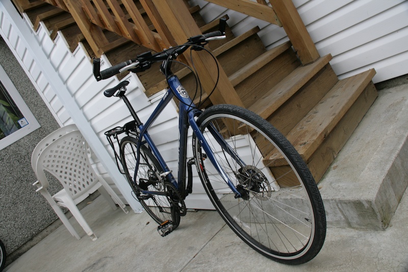 This was Wendy's old commuter, which was far too big for her, so she gave it to me after she got her new bike. This thing absolutely rips! Hydraulic disc brakes and road bike gearing.