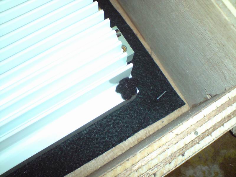 Screwed to the crate through the thick piece of cotton in order for the amp not to be scratched