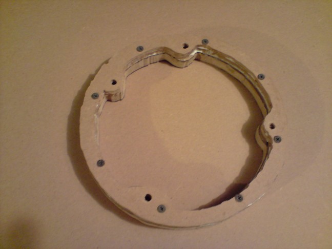 After putting glue on each layer, I screwed it in using the holes where the speaker will be screwed to so it clamps everything together.