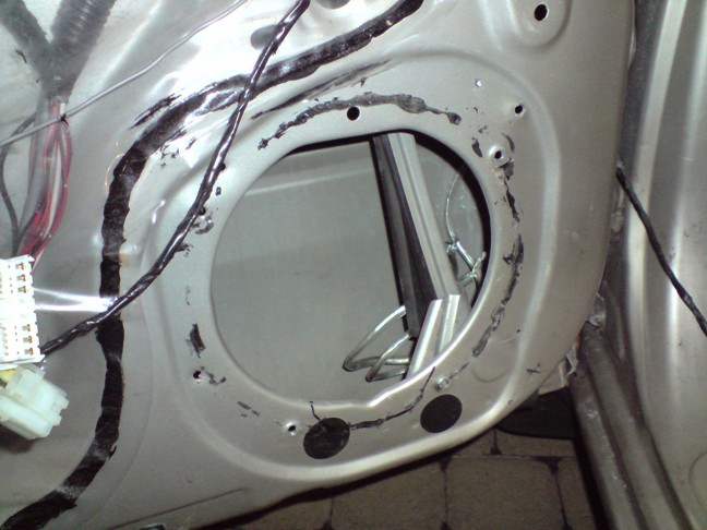 So I had to cut a piece of the door to fit the terminals of the speaker.  Here's where it's marked.