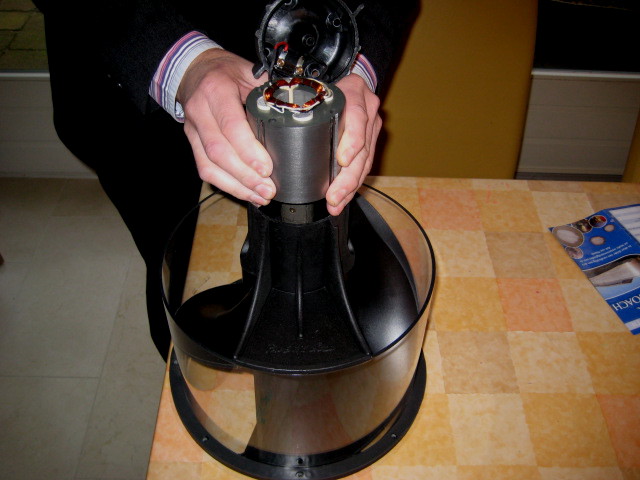 carefully position the coil above the housing; CAUTION! the coil will be pulled down HARD by the very strong magnet, so be prepared, and put both your hands on the edge of the housing to keep control over the coil.