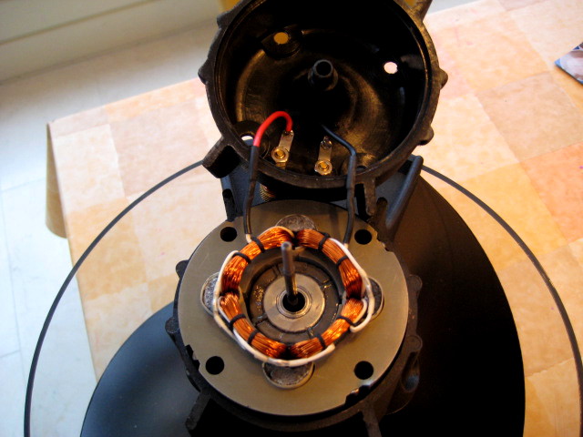 align the coil with the holes in the center piece by looking through the 4 holes and rotate the coil if neccesary.