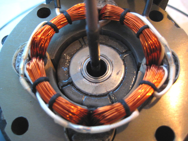 the coil in place, with the coated magnet visible; do NOT try to rotate the rotor before the top cap has been fitted in place and tightened.