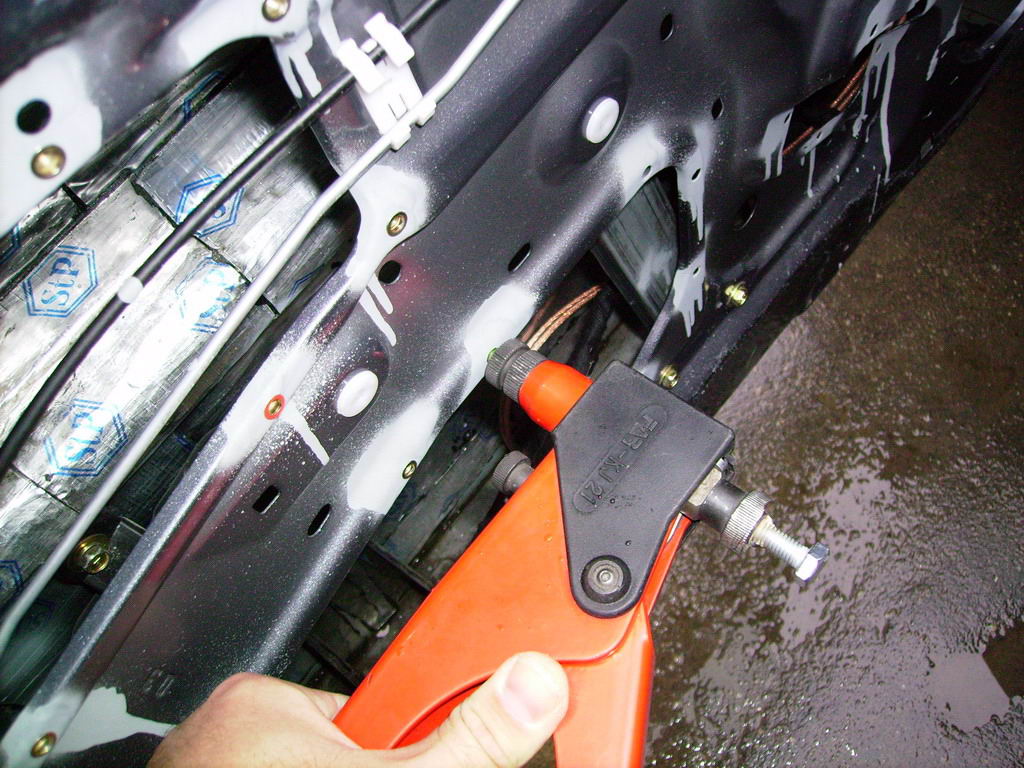 13 Mounting the screw-nuts into the metal of the manufacturing hole edges for fixing duraluminum plates.jpg