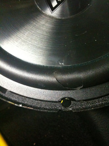 the power drill accidently slipped off the screw and punctured the rubber part of the speaker. (It was 3:30 AM)